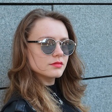a woman wearing sunglasses and a leather jacket